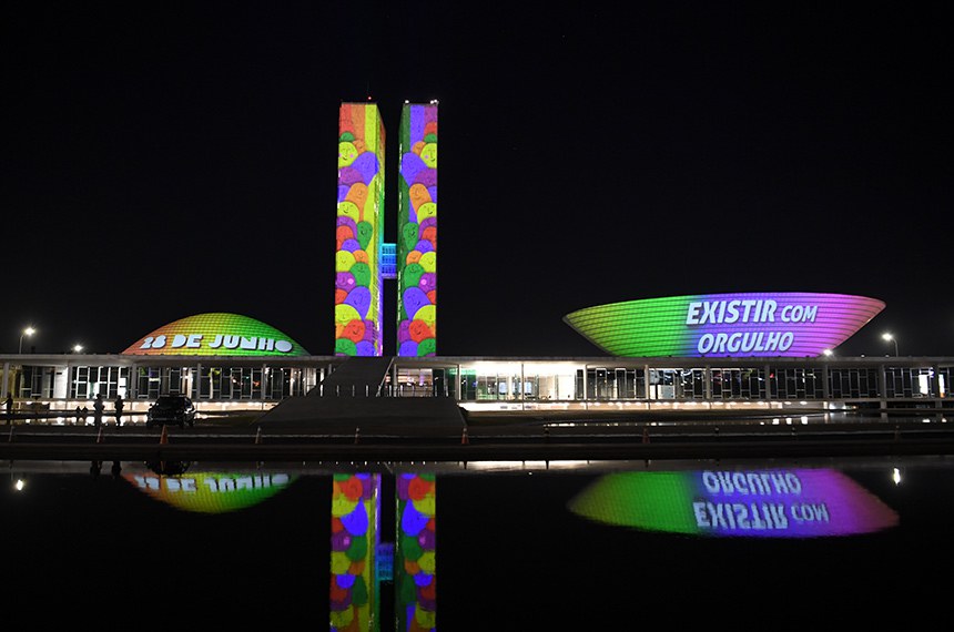 Congresso brasileiro, por onde tramitam projetos de lei, iluminado com as cores da bandeira LGBT+